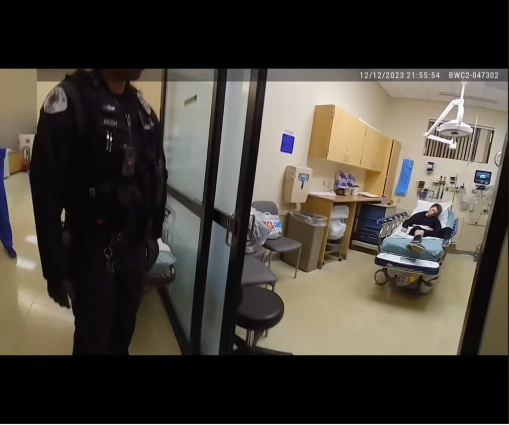 In this bodycam footage released by the Milwaukie Police Department, 26-year-old Jean Descamps can be seen in a hospital bed at the Providence Hospital emergency room in Milwaukie, Oregon.