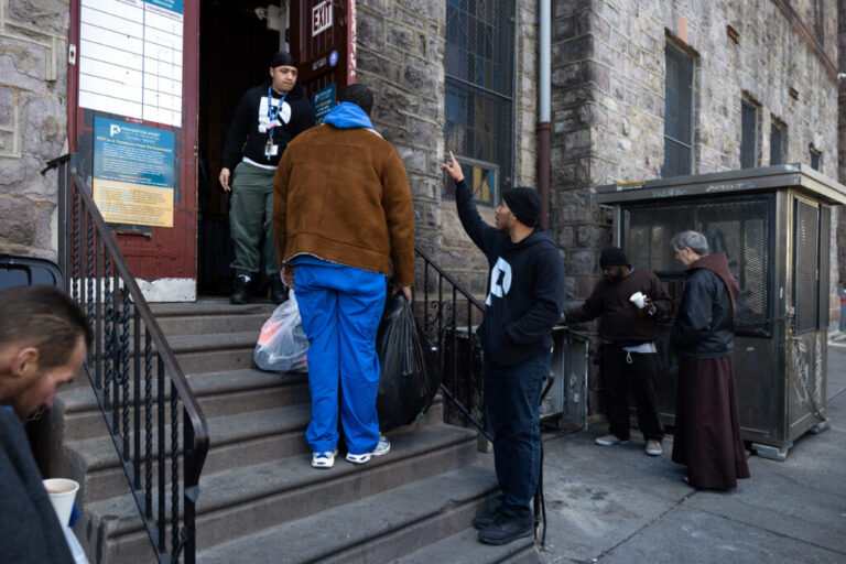 Larry Anderson (center), director of prevention services at Prevention Point, collects donations in the Kensington neighborhood of Philadelphia, Pennsylvania on February 28, 2025.