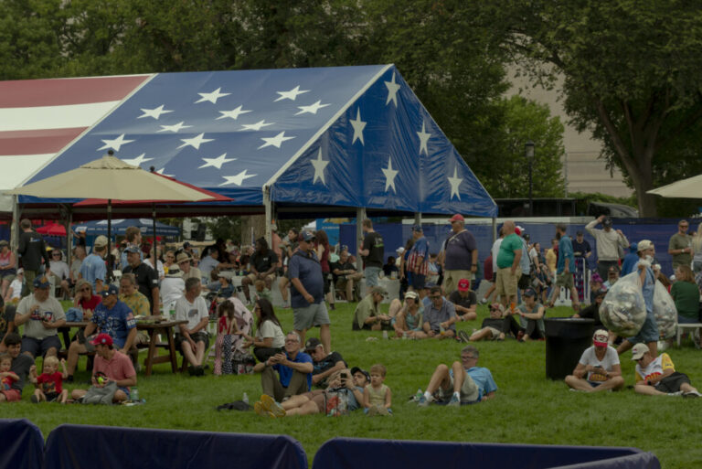 Attendees watch a live streaming of the practice races on the National Mall during the Freedom 250 Grand Prix.