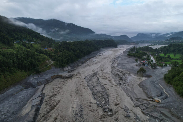 A drone view shows a major section of Pasang Lhamu Highway washed away along the swollen Trishuli River by recent flash floods.