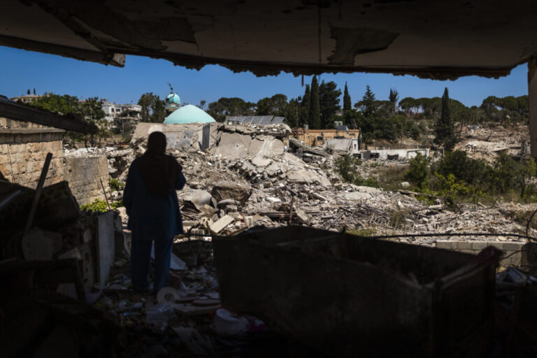 Mahasen Fakih stands outside her destroyed apartment in Zawtar al-Gharbiyah after returning to the village days earlier. The village is the first in a pilot project brokered by the U.S. for Israeli forces to withdraw and Lebanese forces to move in to secure the area.