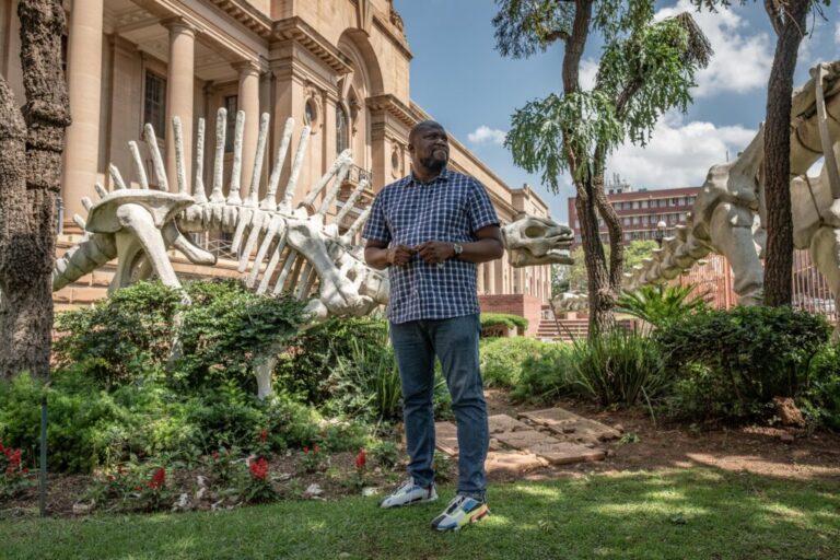 Paleontologist Lazarus Kgasi in front of the Ditsong National Museum of Natural History in Pretoria, South Africa, where he works as a laboratory manager and junior curator. Kgasi, who began working on fossil sites as a hired labourer with no knowledge at all of fossils, has over time emerged as a prominent figure in South African paleontology, and one of only a handful of Black South Africans in what remains an overwhelmingly White-dominated field.
