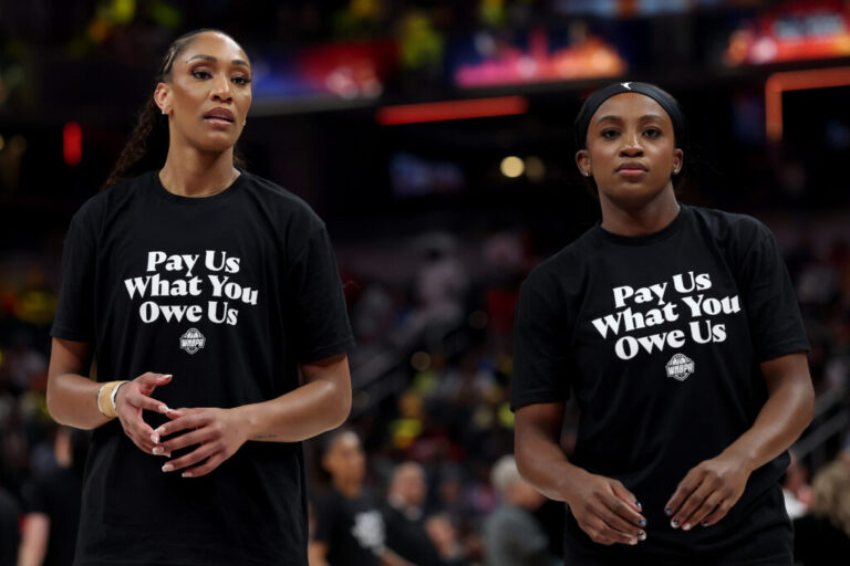 A’ja Wilson, left, and Jackie Young of the Las Vegas Aces wear shirts saying