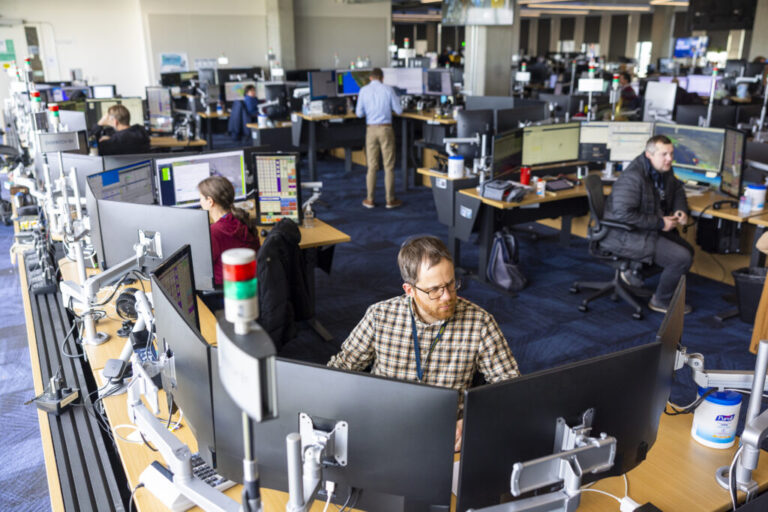 Dispatchers sit surrounded by multiple flatscreen monitors at Alaska Airlines' Network Operations Center near Seattle.