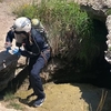 Darshan Chudasama, a graduate student in the Bhamla Lab at Georgia Tech, emerges from Sulphur Cave in Steamboat Springs, Colo. with a vial containing toxic spring water and the worms who live in it.