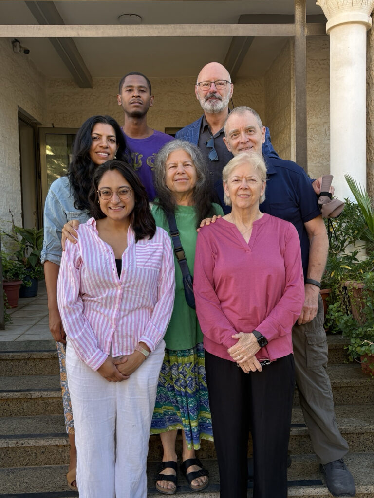 Eight members of a U.S. multifaith delegation to the West Bank and Jerusalem stand in three rows on steps outdoors. The delegation was led by the Rev. Ed Phillips, who's standing in the middle row, on the right side of the frame. Israeli border agents at the Jordan-Israel border refused entry to the group.