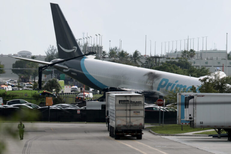 An Amazon cargo plane is seen after it crashed at Miami International Airport on Sunday in Miami. The Federal Aviation Administration said Prime Air Flight 7598 overran the runway while landing around 2 p.m. ET after departing from San Juan, Puerto Rico.