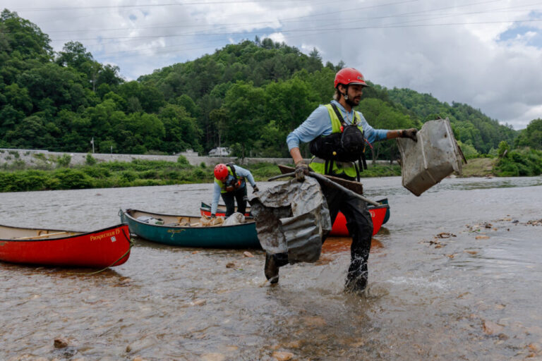 Hayden Cheek cleans debris out of the North Toe River in Western North Carolina.
