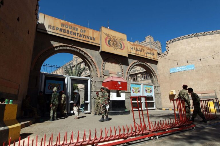 Yemeni security guards stand outside the parliament building in Sanaa in 2015, the same year that a Yemeni lawmaker says he was targeted for assassination. Anssaf Ali Mayo is now suing former U.S. military members who he says were hired to kill him.
