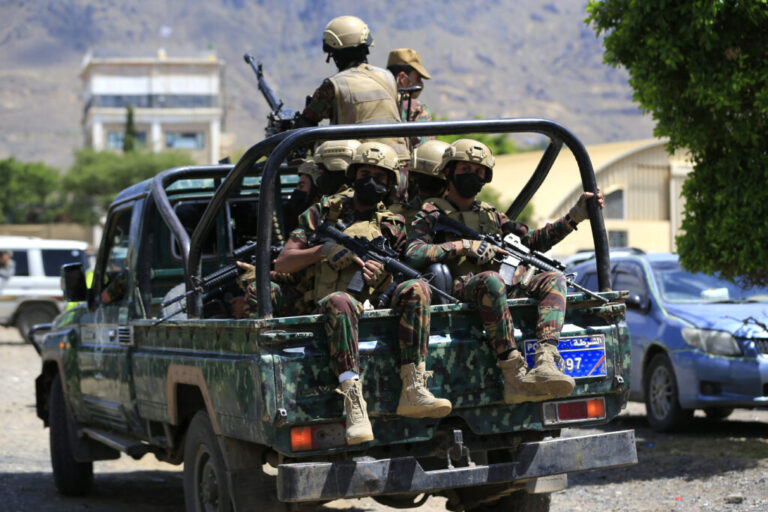 Yemen's Houthi armed forces patrol as Yemeni prisoners loyal to the Houthi authorities arrive in the capital Sanaa on Sep. 12, after being released on the west coast where he and others were being held by Yemen's Saudi-backed government forces.