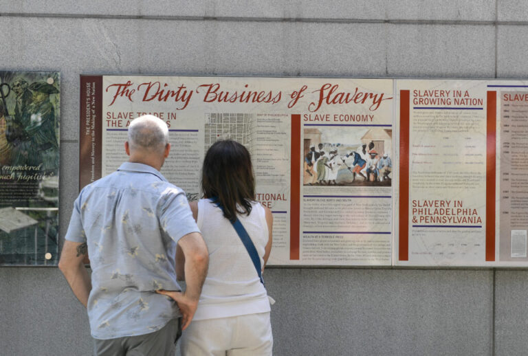 Tourists read a display titled