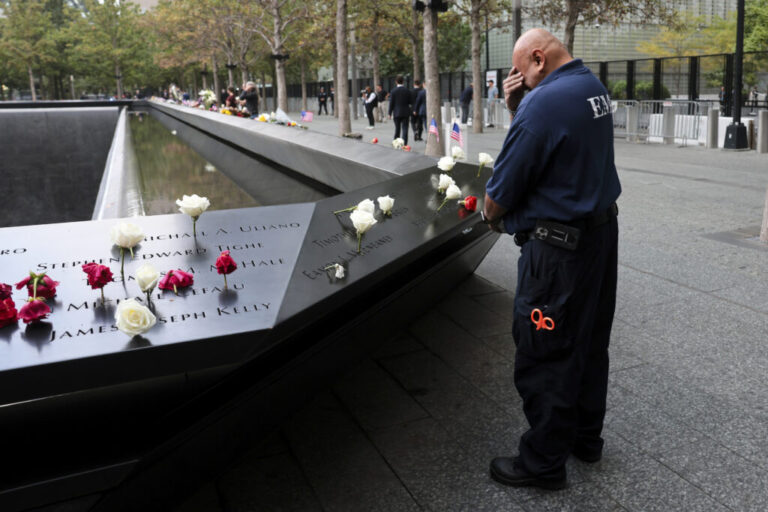 A first responder pauses at the memorial ahead of a ceremony commemorating the 25th anniversary of the September 11th terrorist attacks on the World Trade Center at the National 9/11 Memorial & Museum on Friday in New York City.
