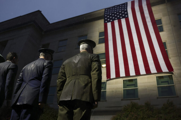 Members of the military and first responders watch as an American flag is unfurled on the side of the Pentagon to mark the 25th anniversary of the September 11th terrorist attacks on September 11, 2026 in Arlington, Va.