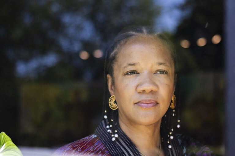 Photographed from about the shoulders up, Robin Rue Simmons is in the entryway of FirstRepair, the nonprofit she founded.