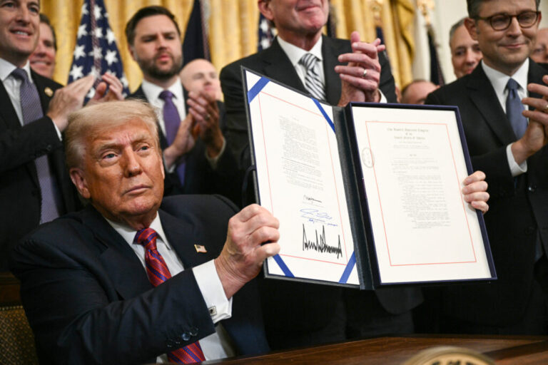 President Trump displays the GENIUS Act — the first major crypto legislation passed by Congress — after signing it in the White House in Washington, D.C., on July 18, 2025.