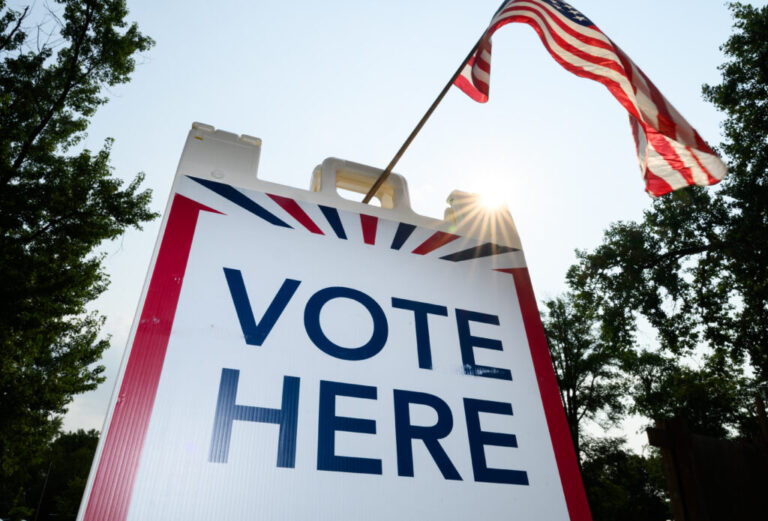 Signage directs voters at a polling place in White Bear Township, Minn., on Aug. 11.