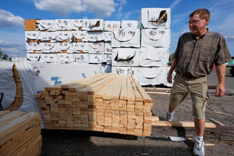 Mel Gutherie, president of Gutherie Lumber, walks among Canadian lumber products on Aug. 25 in Livonia, Mich.