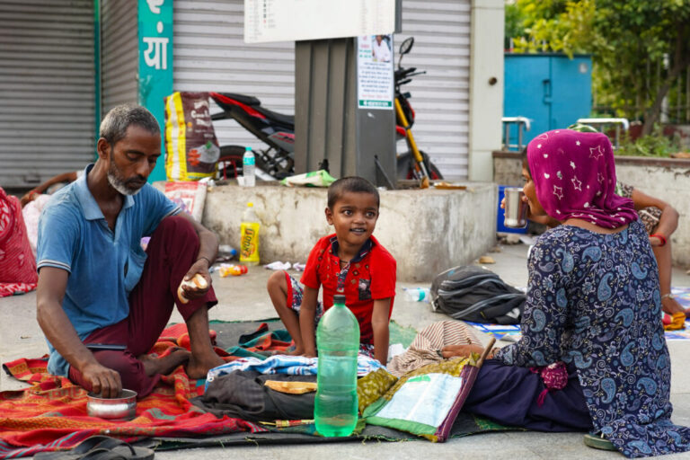 Balraam Singh, 35, eats breakfast with his wife, Nusaa Davii, and their 7-year-old son, Munna, on the pavement outside Safdarjung Hospital in New Delhi, India. The child is receiving treatment for a heart condition, and the family has been sleeping on the pavement outside the hospital for the past 20 days.