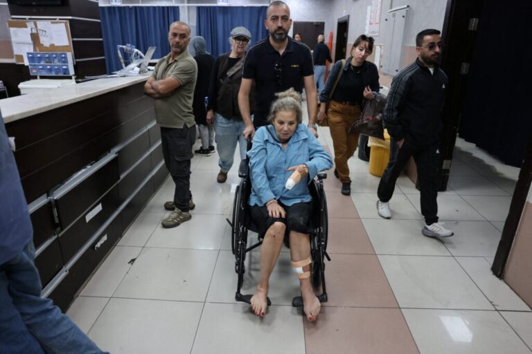 Photojournalist Heidi Levine leaves a hospital emergency room in a wheelchair in the Israeli-occupied city of Ramallah, West Bank. She's being treated after an attack by Israeli settlers as she was photographing Palestinian farmers harvesting their olives, in the Palestinian village of Abu Falah on Friday.