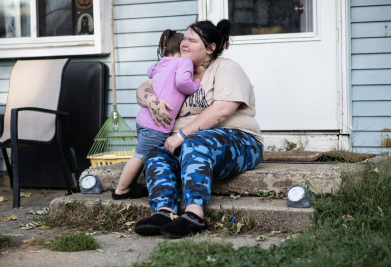 Lewis hugs her daughter, Gianna, outside their home in Indianapolis.