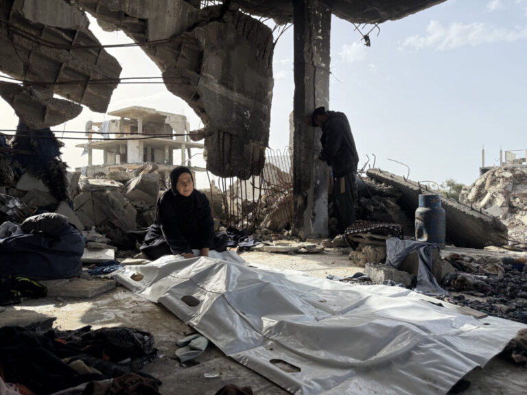 A mother from the Abu Nasr family sits by her son's body in Beit Lahia on February 17, 2026.