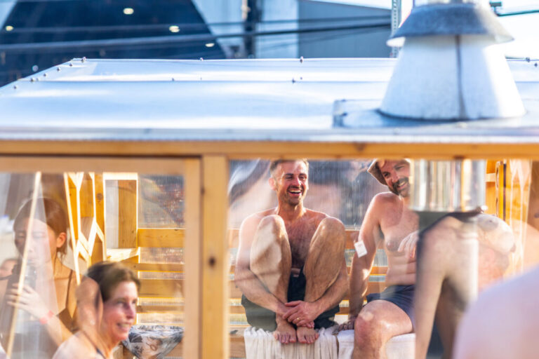 Sauna enthusiast Michael Calcagno, second from right, sits inside a clear-walled wood-fired sauna during the Seattle Sauna Festival in November. Sauna use has taken off as a health practice and scientists are studying its benefits.