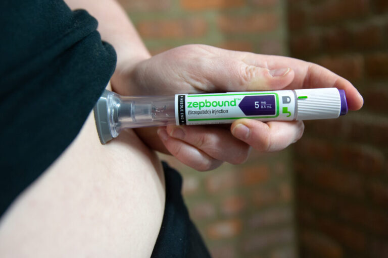 A woman is shown using an injection pen with the word